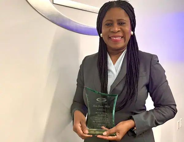 team member holding award